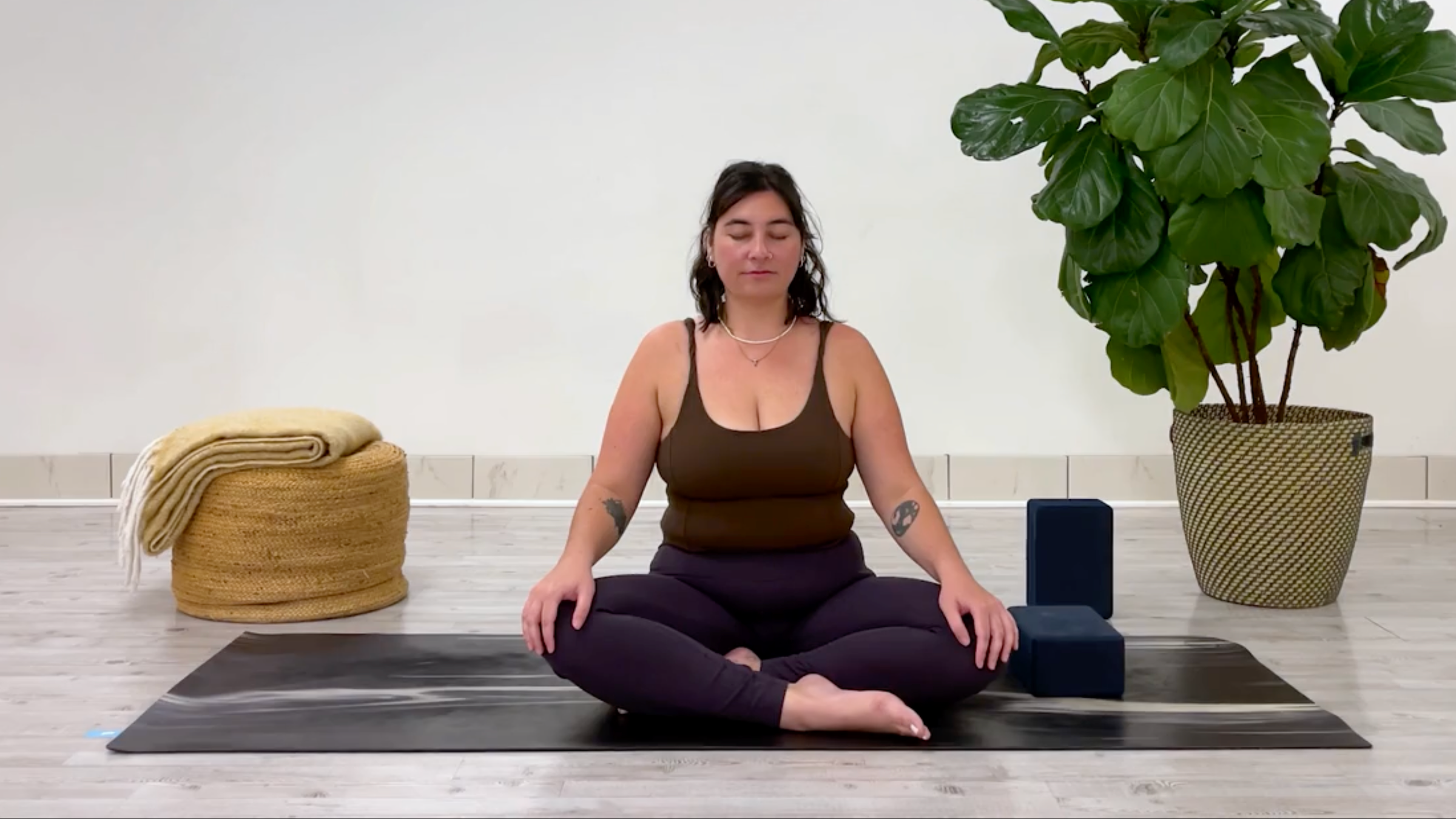 Yoga teacher Taylor Lorenz in Easy Pose